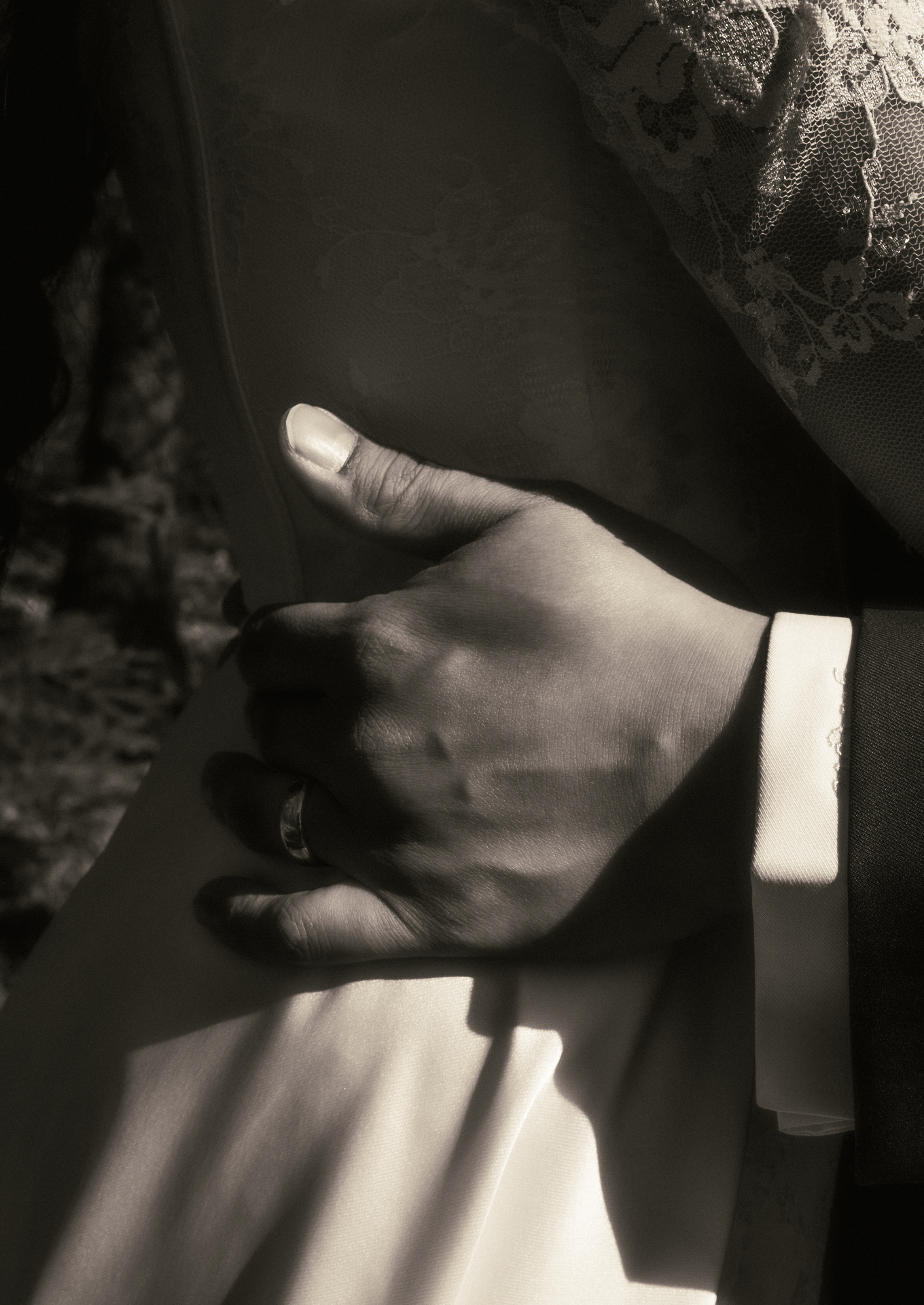 Bride and groom holding each other in soft natural light